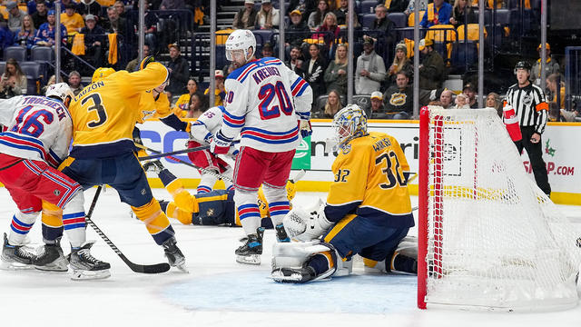 Vincent Trocheck #16 of the New York Rangers scores a goal against Jeremy Lauzon #3 and Kevin Lankinen #32 of the Nashville Predators during an NHL game at Bridgestone Arena on December 2, 2023 in Nashville, Tennessee. 