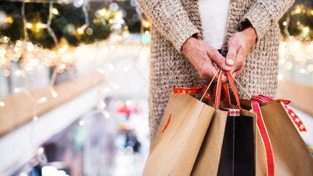 Senior woman with bags doing Christmas shopping. 