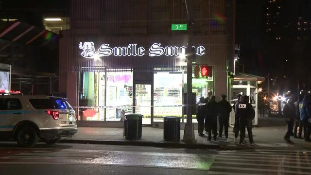 NYPD officers stand outside an Upper East Side smoke shop. 