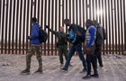 A U.S. Customs and Border Protection officer directs migrants at the US-Mexico border in Lukeville, Arizona, US, on Monday, Dec. 11, 2023. 