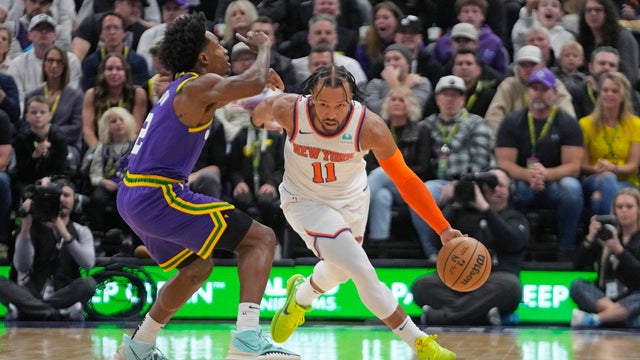 New York Knicks guard Jalen Brunson (11) drives as Utah Jazz guard Collin Sexton (2) defends during the first half of an NBA basketball game Wednesday, Dec. 13, 2023, in Salt Lake City.