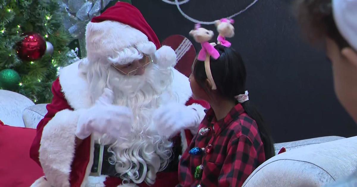 Santa uses sign language to communicate with children at Dolphin Mall
