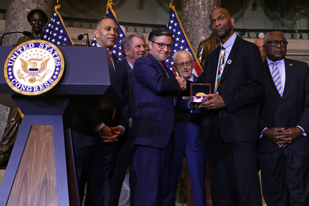 Larry Doby Jr., son of professional baseball player Larry Doby, receives a Congressional Gold Medal on behalf of his father from U.S. Speaker of the House Rep. Mike Johnson (R-LA) during a ceremony at the U.S. Capitol on December 13, 2023 in Washington, D 