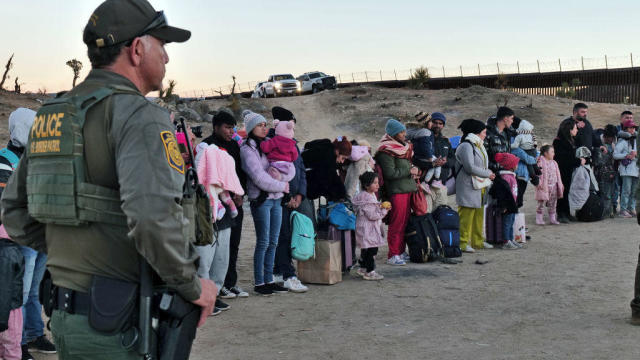 Migrants attempting to cross into the U.S. from Mexico are detained by U.S. Customs and Border Protection at the border Dec. 14, 2023, in Jacumba Hot Springs, California. 
