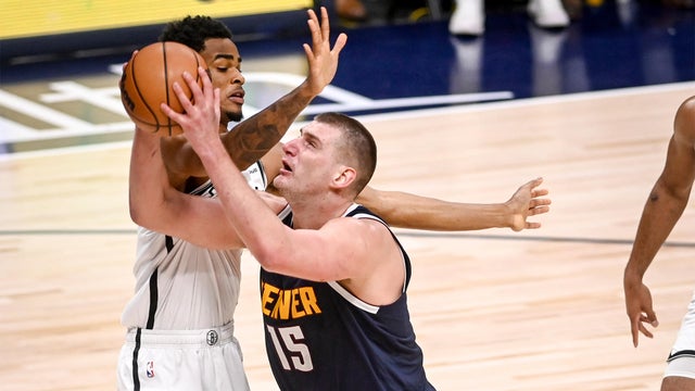 Nikola Jokic (15) of the Denver Nuggets drives on Nic Claxton (33) of the Brooklyn Nets during the third quarter at Ball Arena in Denver on Thursday, December 14, 2023.