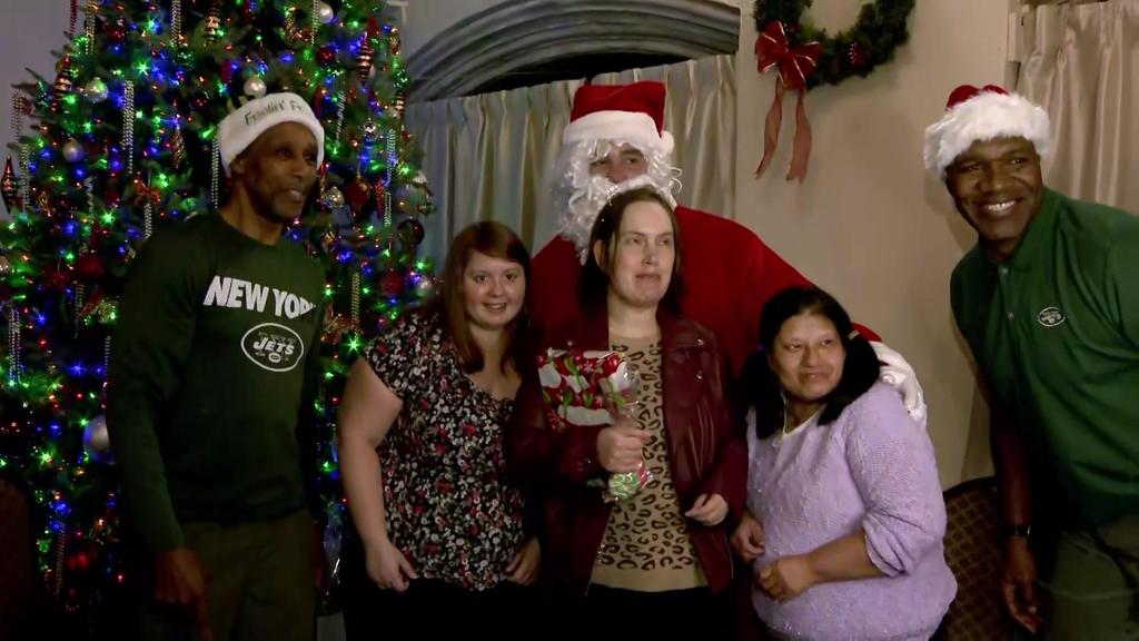 Former New York Jets players lift holiday spirits at party for adults
with autism