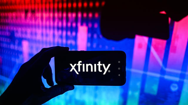 In this photo illustration a XFinity logo is displayed on a 