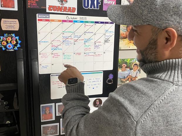 Rafael Rodriguez checks the family calendar 
