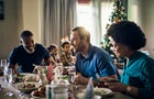 Friends, christmas dinner, holiday celebration in home, food and happy smile, festive holiday in home with laugh. Family, dinner table and happiness for xmas, meal and conversation, speaking or house 