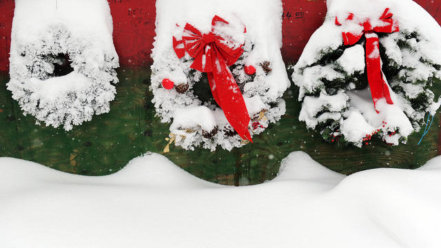 Colorful wreaths are blanketed in snow at the East Colfax Christmas Tree Lot at Monaco Blvd and E. Colfax Ave. on Thursday, December 22, 2011. The lots has sold trees at the location for 57 years. Cyrus McCrimmon, The Denver Post 