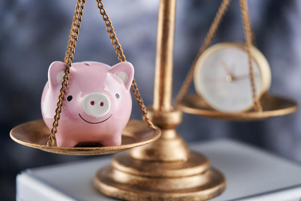 Balance of piggy bank and alarm clock - time and money,Malaysia 