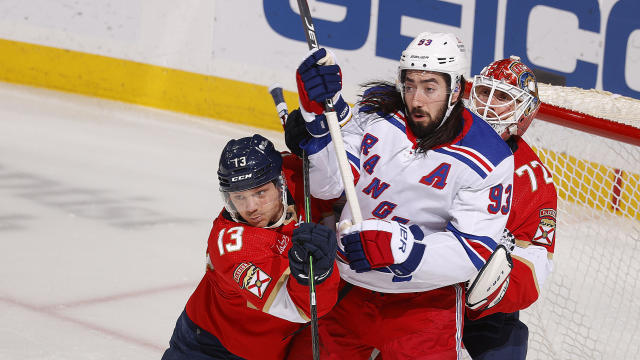 Mika Zibanejad #93 of the New York Rangers tangles with Sam Reinhart #13 of the Florida Panthers at the Amerant Bank Arena on December 29, 2023 in Sunrise, Florida. 