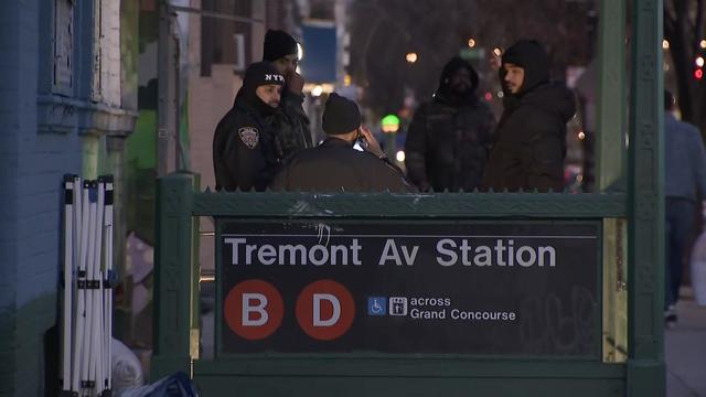 NYPD officers stand at the entrance to the Tremont Avenue Station. 