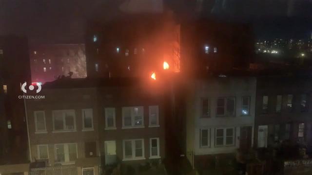 Flames can be seen shooting out of the windows of a Bronx apartment building. 