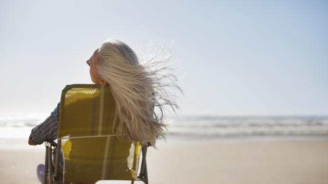 Womans hair blowing in wind on beach 
