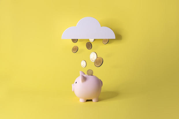 Financial freedom conceptual piggy bank with gold coins still life. 