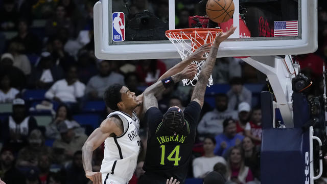 New Orleans Pelicans forward Brandon Ingram (14) goes to the basket against Brooklyn Nets center Nic Claxton in the first half of an NBA basketball game in New Orleans, Tuesday, Jan. 2, 2024. 