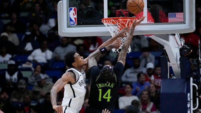 New Orleans Pelicans forward Brandon Ingram (14) goes to the basket against Brooklyn Nets center Nic Claxton in the first half of an NBA basketball game in New Orleans, Tuesday, Jan. 2, 2024.