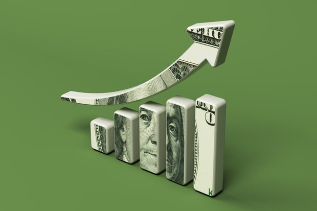 Financial graph and 100 dollar banknote. On a green-colored background.