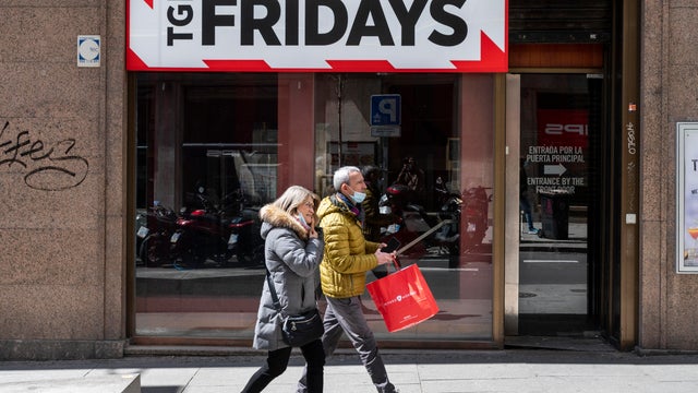 Pedestrians walk past the American casual dining restaurant
