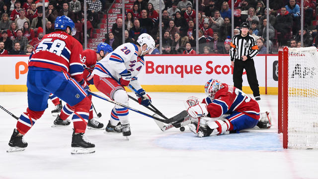 Goaltender Sam Montembeault #35 of the Montreal Canadiens stretches out the pad and glove near Chris Kreider #20 of the New York Rangers during the third period at the Bell Centre on January 6, 2024 in Montreal, Quebec, Canada. 