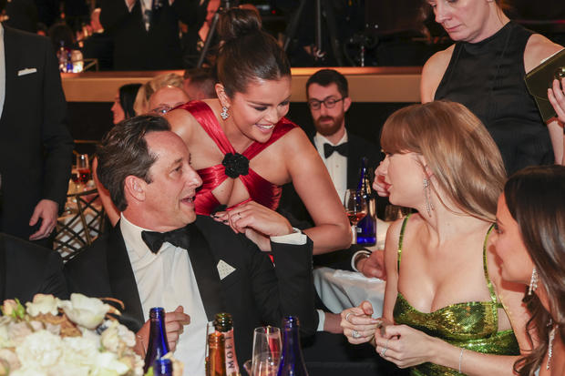 L-R: David Greenbaum, Selena Gomez and Taylor Swift at the 81st Golden Globe Awards 