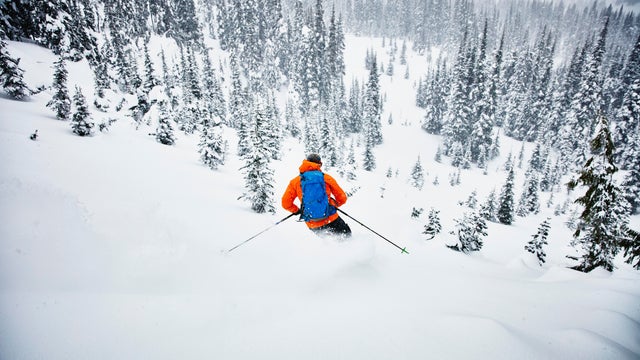 Man skiing though fresh snow while on backcountry ski tour