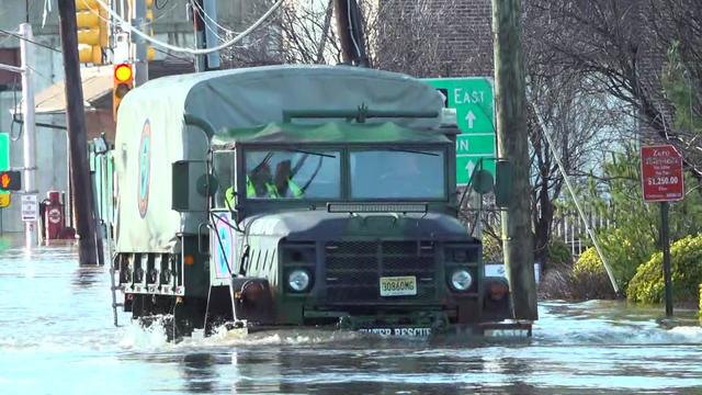 A water rescue vehicle drives through a flooded street in Lodi. 