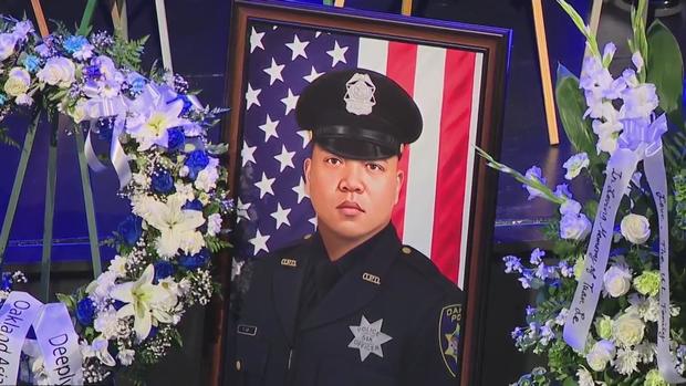 Officer Tuan Le portrait at public memorial 