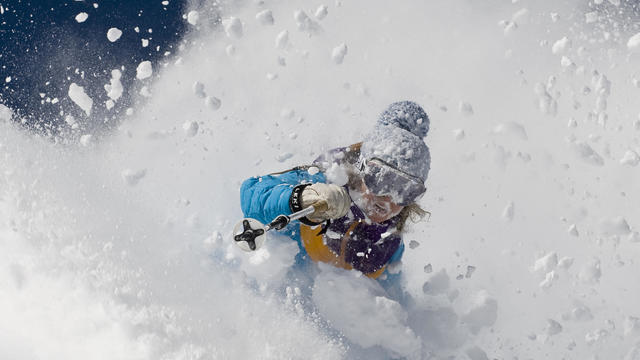 Woman skiing deep powder at Alta, Utah 