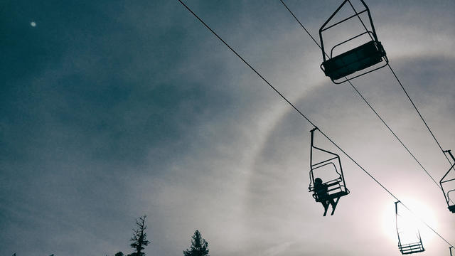 Young child rides on a chair lift all alone 