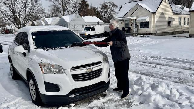 Cleaning snow off car 
