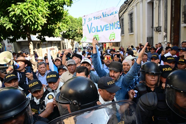 Supporters of Guatemala's President-elect, Bernardo Arevalo, clash with police during a protest outside the Congress against the suspension of the inauguration of the new legislature, shortly before Arevalo's inauguration ceremony in Guatemala City, Jan. 14, 2024