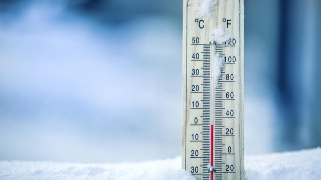 Thermometer on snow shows low temperatures - zero. Low temperatures in degrees Celsius and fahrenheit. Cold winter weather - zero celsius thirty two farenheit 