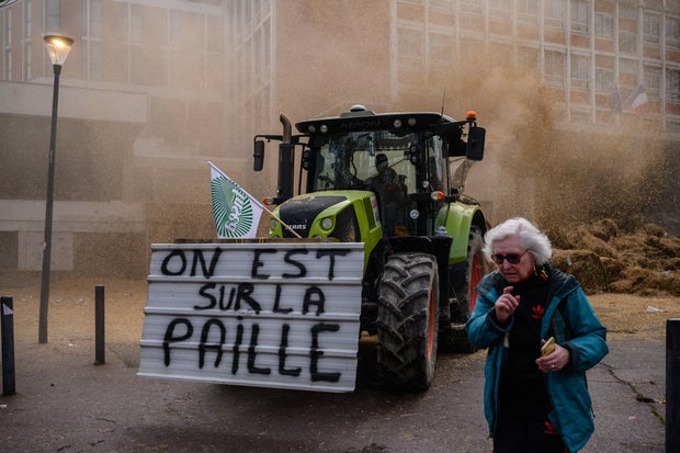 A French expression signifying being financially ruined) dumps waste and manure outside a government administrative building as farmers from the Midi-Pyrenees region of southwestern France take part in a protest against taxation, declining income and difficult work conditions, in central Toulouse, Jan. 16, 2024