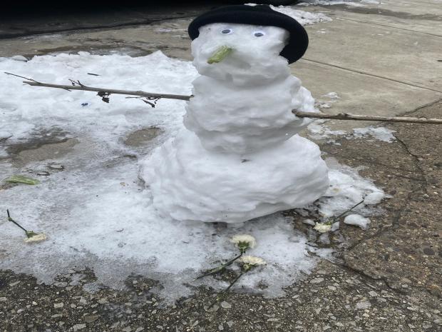 snowman-given-flowers-in-west-philly-deneir-holland.jpg 