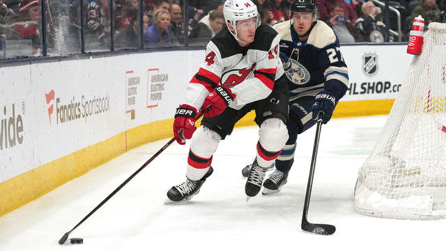 Nathan Bastian #14 of the New Jersey Devils skates with the puck against Adam Boqvist #27 of the Columbus Blue Jackets during the third period at Nationwide Arena on January 19, 2024 in Columbus, Ohio. 