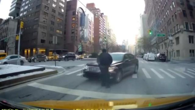 Dash cam video shows the driver of a sedan about to strike an NYPD officer. 