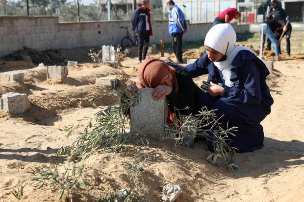 A Palestinian woman reacts at the grave of her son killed in an Israeli strike, in Khan Younis