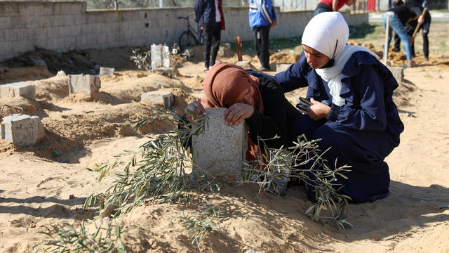 A Palestinian woman reacts at the grave of her son killed in an Israeli strike, in Khan Younis 