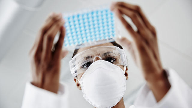 Woman examining laboratory samples 