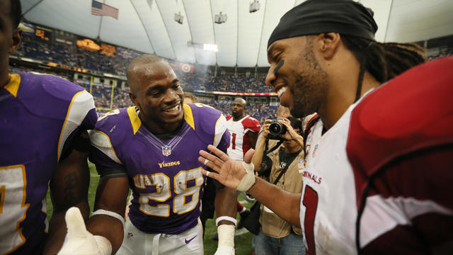 Minnesota Vikings running back Adrian Peterson (28) shook hands with Arizona Cardinals wide receiver Larry Fitzgerald (11) after Sunday 'sNFL game between the Minnesota Vikings and the Arizona  Card Cardinals  at the Mall of America Field Sunday Oct. 21, 