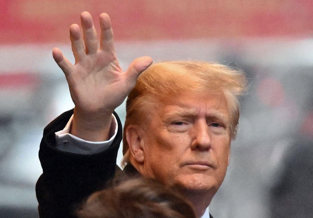 Former President Donald Trump waves as he departs for his defamation trial in New York on Jan. 25, 2024.