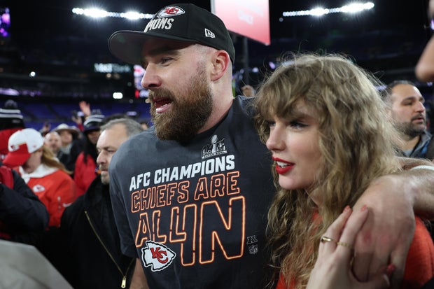 Kansas City Chiefs' Travis Kelce celebrates with Taylor Swift