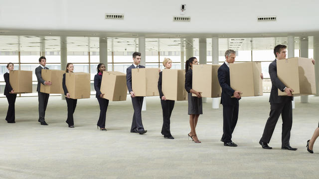 line of business people carrying cardboard boxes 