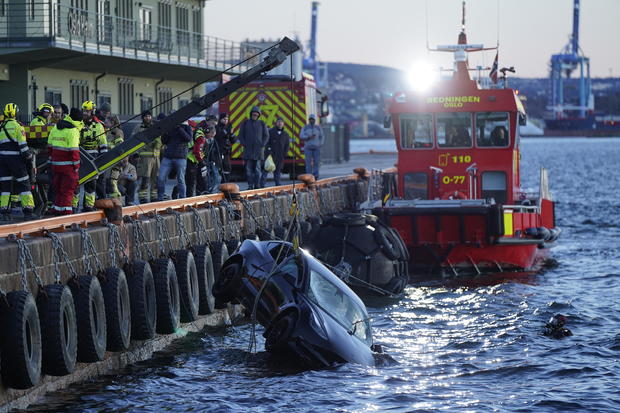 Rescue personnel retrieve a Tesla car from the water after it plunged into the Oslofjord on Feb. 1, 2024, in Oslo. 