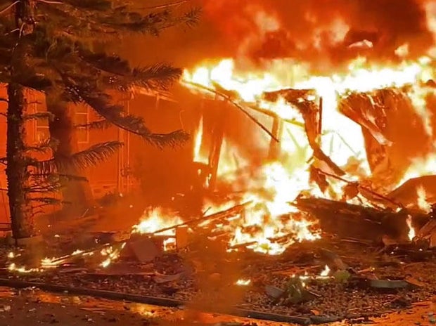 A fire ignited by a small plane crash engulfs a home in Clearwater, Florida, Feb. 1, 2024.