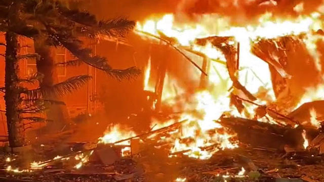 A fire ignited by a small plane crash engulfs a home in Clearwater, Florida, Feb. 1, 2024. 
