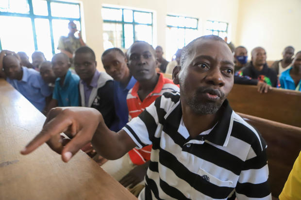 Paul Mackenzie, right, leader of an alleged starvation cult accused of convincing hundreds of followers to starve themselves to death, including children, is seen at the Shanzu Court in Mombasa, Kenya, Aug. 10, 2023. 