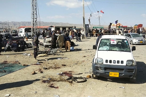 Security personnel inspect the site of a bomb blast outside the office of an independent candidate in Pishin district, about 30 miles from Quetta, Pakistan, Feb. 7, 2024, on the eve of Pakistan's national elections